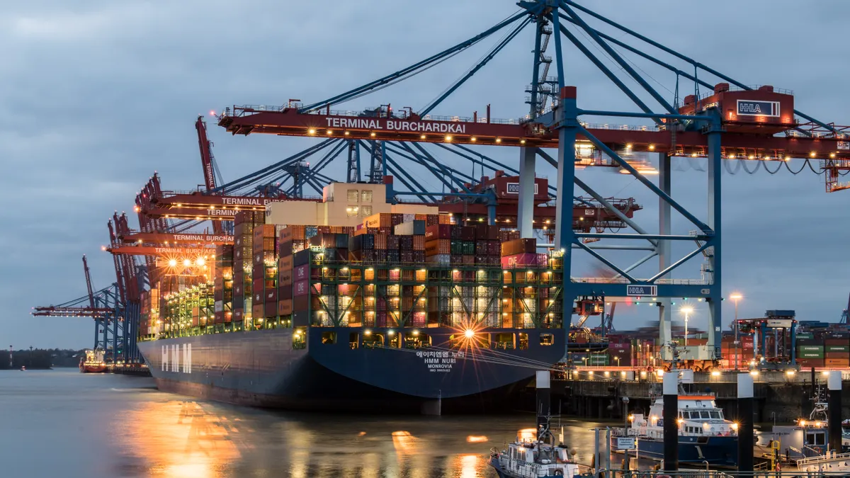 Container ships moored at Terminal Burchardkai in Hamburg, Germany during evening hours.