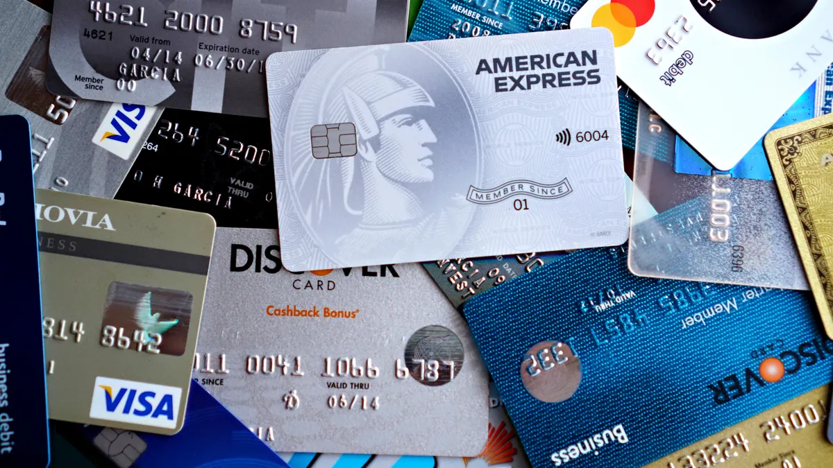 Close-up image of various credit and debit cards including Visa, MasterCard, American Express, and Discover.