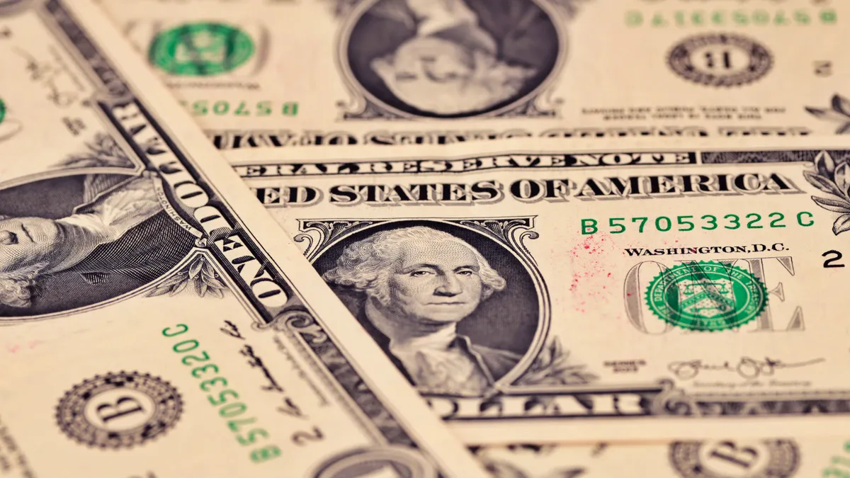 Detailed close-up of US one dollar bills showcasing intricate design and texture.